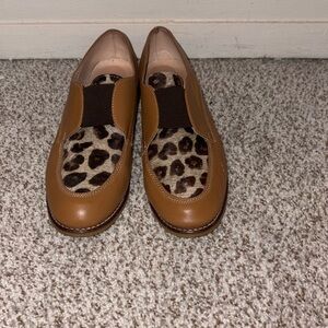 Gently used Monarco cow skin cheetah print and tan loafers.